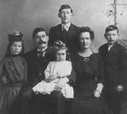 James O'Rouark and his family.  LtoR: Allegra Catherine O'Rouark, James Edward O'Rouark, Ellen (Nellie) Alexander O'Rouark, Douglas James O'Rouark, Gerald Alexander O'Rouark (in back), Elaine O'Rouark (sitting in Dad's lap).
