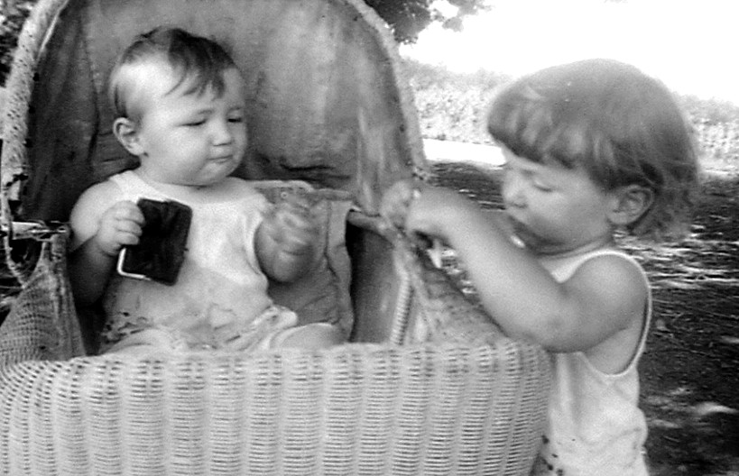 Frank Vautier in baby buggy while Michael looks on