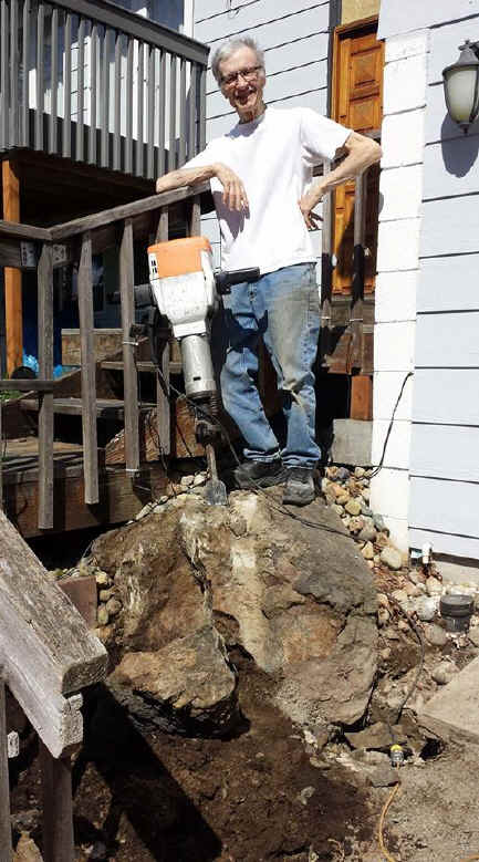 Dominic vautier next to his jackhammer busting rock